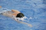 Young Man Swimming The Front Crawl In A Pool Stock Photo