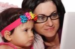 Girl And Mother With Laptop Stock Photo