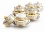 Several Golden Crown Cosmetic Jar On White Background Stock Photo