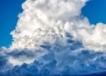 White Dense Clouds In The Bright Blue Sky Stock Photo