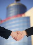 Handshaking Business People Stock Photo