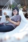 Portrait Of Beautiful Asian Woman Relaxing Time Reading Book On Cradle Happiness Emoton With Smiling Face Stock Photo