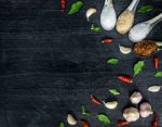 Top View Of Food Ingredients And Condiment On The Table, Ingredients And Seasoning On Dark Wooden Floor Stock Photo