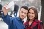 Young Couple Using Smart Phone Stock Photo