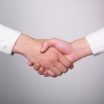 Handshaking Female Hands Stock Photo