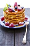 Pancakes With Honey And Berries On White Background Stock Photo