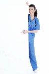 Smiling Young Nurse Pointing Blank Board Stock Photo