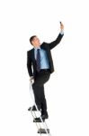 Businessman On Ladder Stock Photo