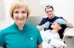 Orthodontist, Patient And Assistant In Clinic Stock Photo