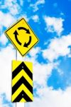 Traffic Circle Road Sign On Beautiful Sky Stock Photo