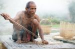 Older Asian Men Sit Are Weaving Stock Photo