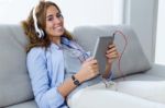 Beautiful Young Woman Listening To Music With Digital Tablet At Stock Photo