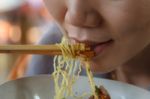 Woman Eating Noodles Stock Photo