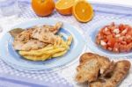 Turkey Steak With French Fries And Tomato Salad Stock Photo