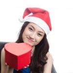 Young Women Wearing Christmas Hats Stock Photo