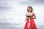 Beautiful Woman Wear Red Evening Dress Hold A Bouquet Of Flowers Stock Photo