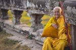 An Unidentified Old Buddhist Female Monk Dressed In Orange Toga Stock Photo