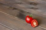 Fresh Tomatoes On The Dark Wooden Table Stock Photo