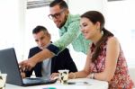 Casual Executives Working Together At A Meeting With Laptop Stock Photo