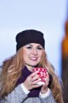 Attractive Young Stylish Blonde Girl Drinks Hot Drink From A Mug Stock Photo