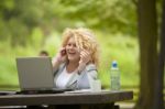 Business Lady Using Laptop In Park Stock Photo