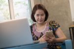 Woman Using Mobile Phone At Home Stock Photo