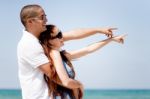 Couple Pointing The Sea Stock Photo