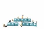 Miniature Worker Team Building Word Happy New Year On White Background Stock Photo