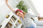 Beautiful Young Woman Listening To Music At Home Stock Photo