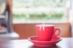 Red Coffee Cup On Wooden Table Stock Photo