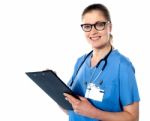 Friendly Female Doctor With A Clipboard Stock Photo