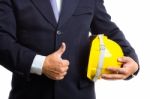 Engineer Holding Helmet And Left Thump Up Stock Photo