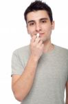 Young Man Applying Lip Balm Stock Photo