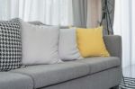 Yellow And Grey Pillows On Modern Sofa Stock Photo