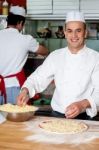 Male Chefs Actively Working In Kitchen Stock Photo