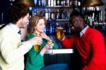 Group Of Three Friends In A Bar Drinking Beer Stock Photo