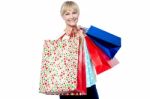 Vivacious Woman Holding Colorful Shopping Bags Stock Photo