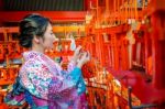 Women In Traditional Japanese Kimonos At Fushimi Inari Shrine In Kyoto, Japan Stock Photo