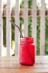 Iced Drink In Red Glass On Wooden Table Stock Photo