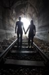 Couple Walking Together Through A Railway Tunnel Stock Photo