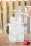 Drinking Water Is Poured Into Iced Glass Stock Photo