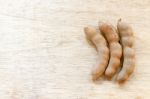 Sweet Ripe Tamarind Pods On Wood Background Stock Photo