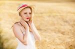 Lonely Beautiful Young Blonde Girl In White Dress With Straw Hat Stock Photo