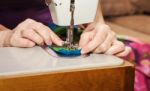 Woman's Hands Sewing On The Sewing Machine Stock Photo