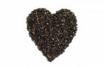 Black Sesame In Heart Shape Stock Photo