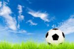 Soccer Ball On Green Grass With Blue Sky Stock Photo