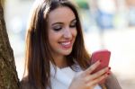 Beautiful Girl Chatting With Mobile Phone In Autumn Stock Photo