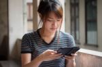 Portrait Of Thai Adult Beautiful Girl Using Her Tablet Stock Photo