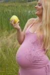 Pregnant Woman Holding Apple Stock Photo