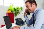 Side Profile Of A Businessman Busy In Office Work Stock Photo